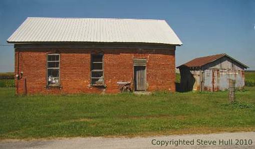 An old abandoned rural brick building.